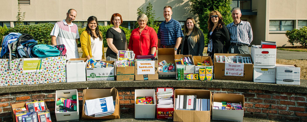City employees donate school supplies, cash to Kent-Meridian High